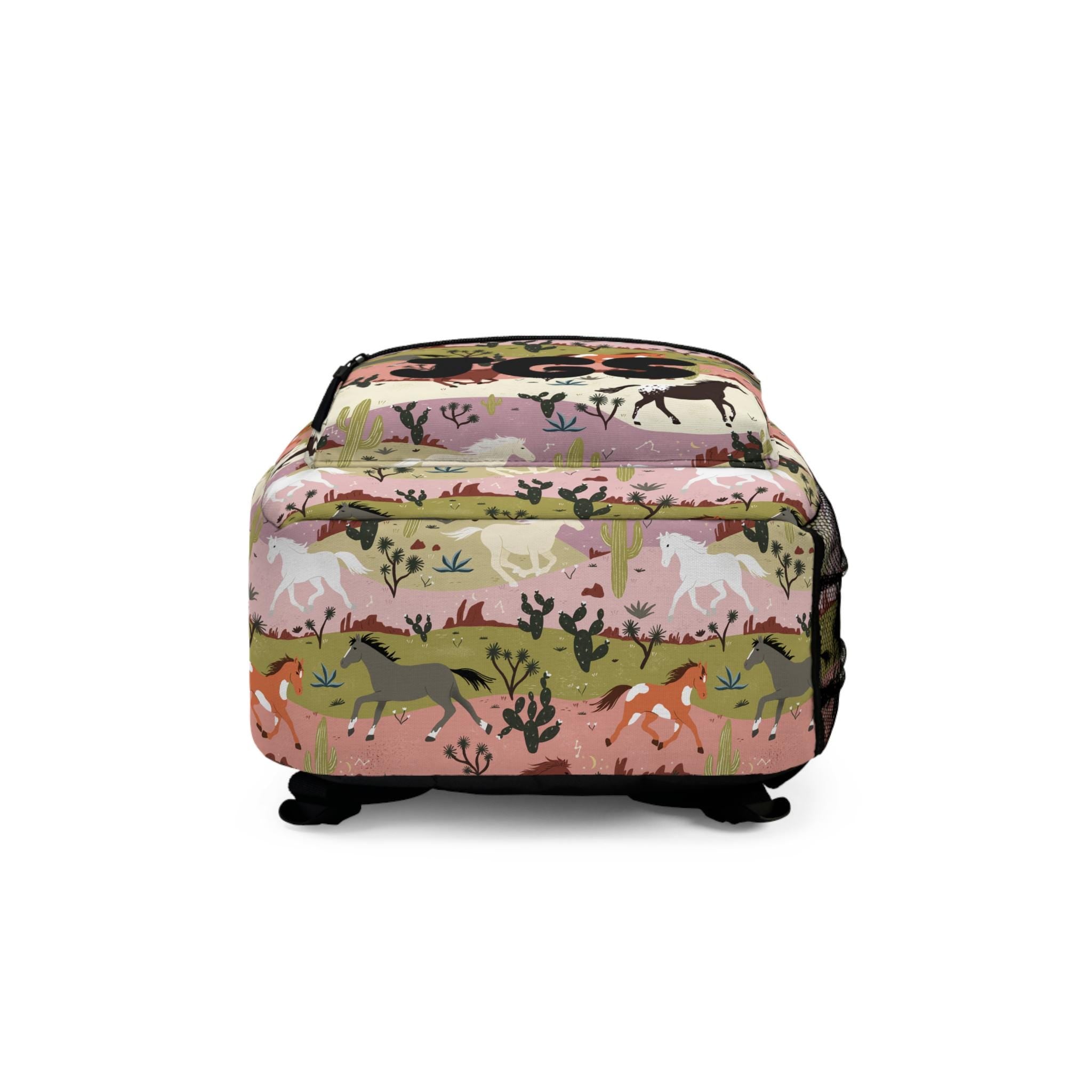 Featuring a bold allover horse and nature design, this bag is a must-have for any young horse lover or free spirit. Personalize it with a name or initials for an extra special touch that makes it uniquely theirs!

✓ Personalize with name or initials
✓ Durable & lightweight — great for daily use
✓ 4 compartments to keep essentials organized
✓ Padded back + adjustable straps for all-day comfort
✓ Perfect for school, sleepovers, or nature outings