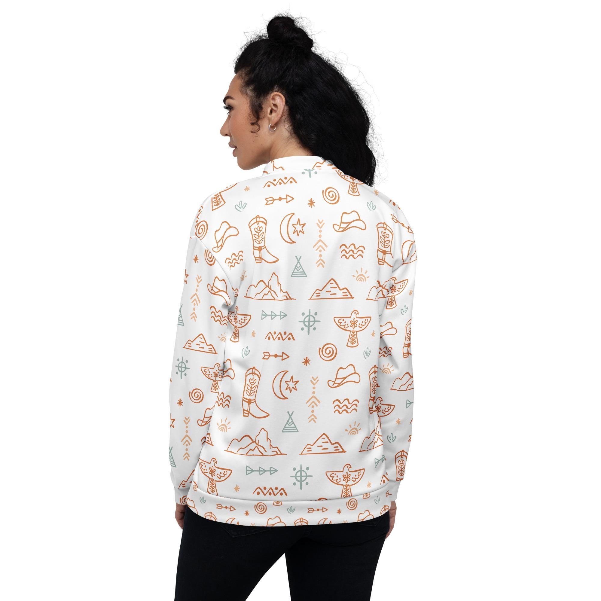 Beige & White Western Motif Bomber Jacket | Fall Cowgirl Style 🤠
Saddle up for cooler days in this bold and cozy Cowboy-themed jacket! Featuring a dreamy blend of classic Western elements—cowboys, cacti, sunbursts, thunderbirds, and steer heads—this all-over print bomber is a perfect statement piece for fall.

✓ Cozy brushed fleece interior
✓ Unisex relaxed fit—perfect for layering
✓ Two roomy self-fabric pockets
✓ All-over Western print in soft beige & white tones