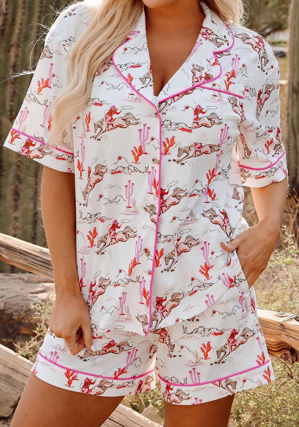 Pink Cowgirl Pajama Short Set 🩷
Yeehaw and sweet dreams, darlin&#39;!

Embrace your inner cowgirl with this adorable pink pajama set, designed for the wild-at-heart who also love their beauty sleep. This western short set is as cozy as it is cute—perfect for warm summer nights, bachelorette parties, birthday gifts, or just treatin’ yourself to some cowgirl charm.

How cowgirl-tastic is this set?!
✓ Features a short-sleeve button-up top with hot pink piping