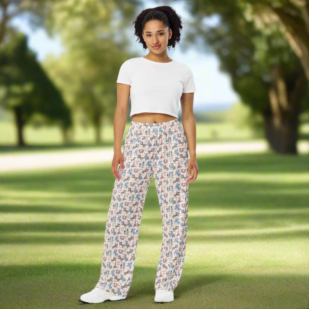 All-Over Print Cowgirl Wide-Leg Pants | Retro Western Unisex Lounge Pants 
Saddle up in style with these all-over print wide-leg pants, covered in bold retro cowgirl art! Featuring cowgirls riding broncs, rearing horses, and strolling alongside their trusty steeds, this design captures the true spirit of the Wild West. Set against a dusty blue and peach plaid backdrop, with classic cowboy icons like skulls, cacti, and horseshoes, these pants are a Western standout.
✓ Relaxed unisex fit
