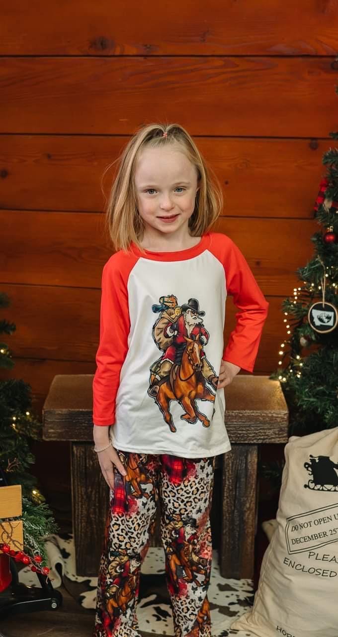 Cowboy Santa Pajamas featuring Santa riding his best horse in a collage of cheetah print, buffalo plaid and Cowboy Christmas spirit! PJ set in 3/6 months baby through adult 3x! Pajamas for EVERYONE!