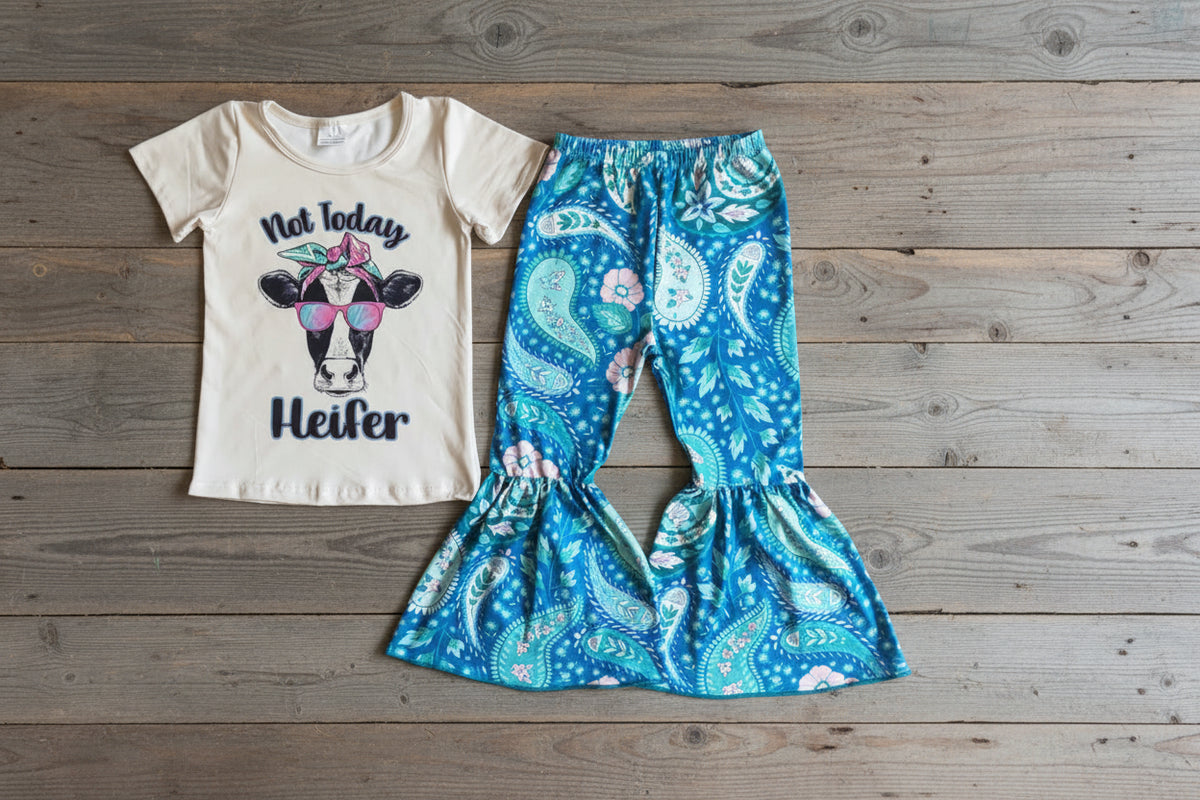 White t-shirt with cow graphic and text 'Not Today Heifer' and PAISLY blue patterned pants on a BARNWOOD background