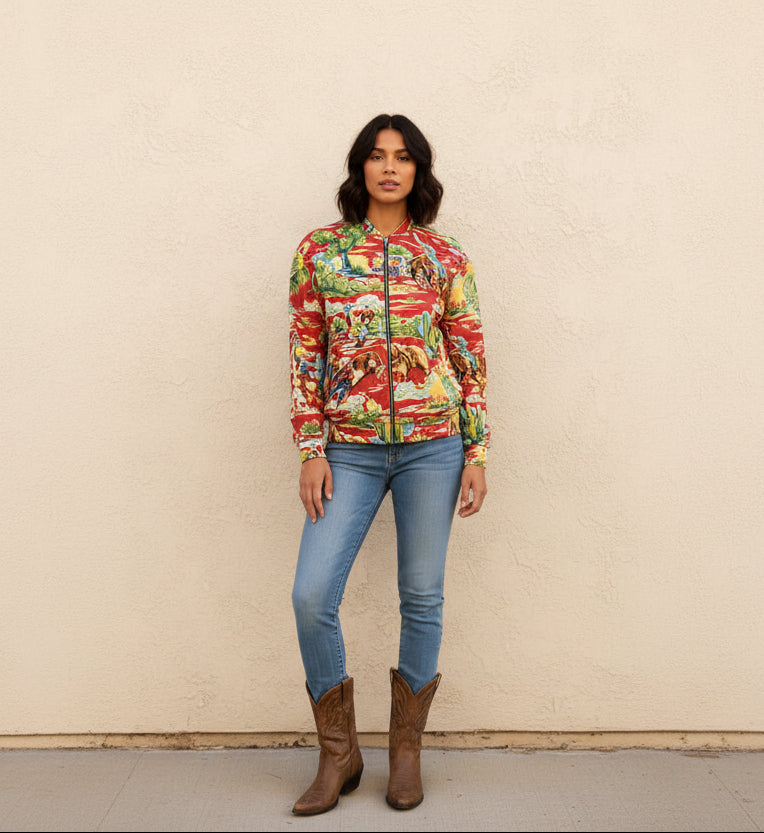 woman wearing red vintage cowboy bomber jacket standing against wall