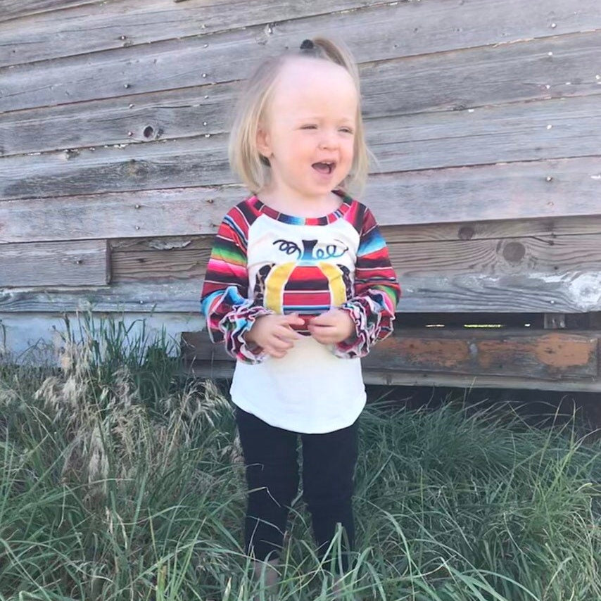 Fall Stripes Pumpkin Ruffle Sleeve Shirt. This Fall Shirt features a pumpkin with Fall serape stripes, cheetah print and glitter gold. The neckline and sleeves are festive serape stripes with wrist ruffles. So cute!